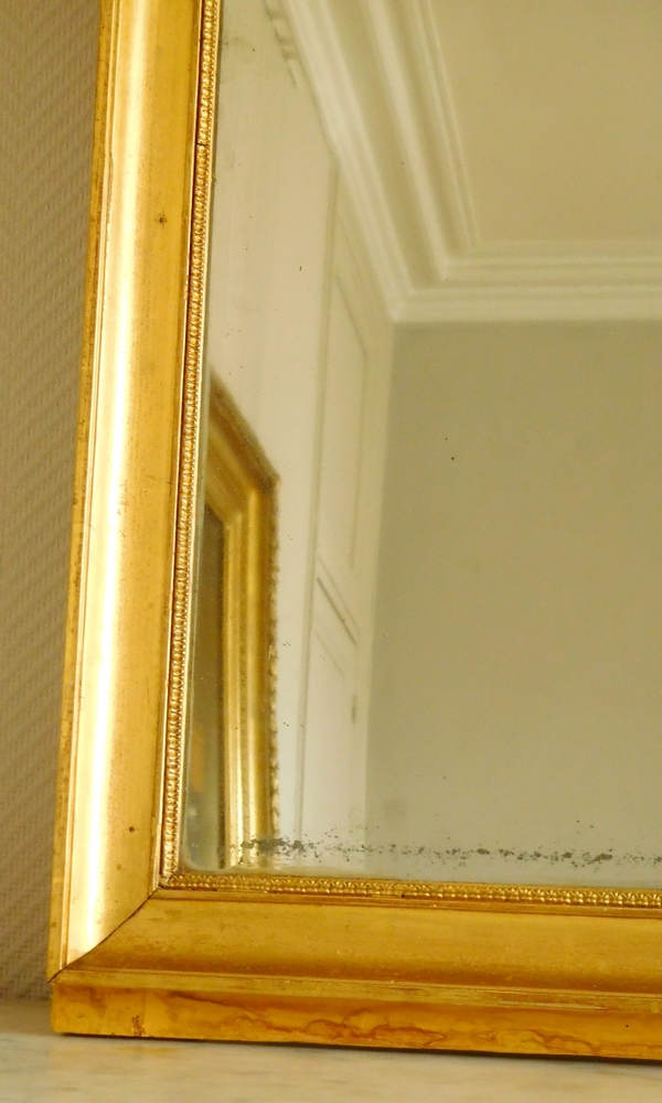 Miroir d'entre deux ou de cheminée d'époque Empire en bois doré, glace au mercure - 141cm x 76cm